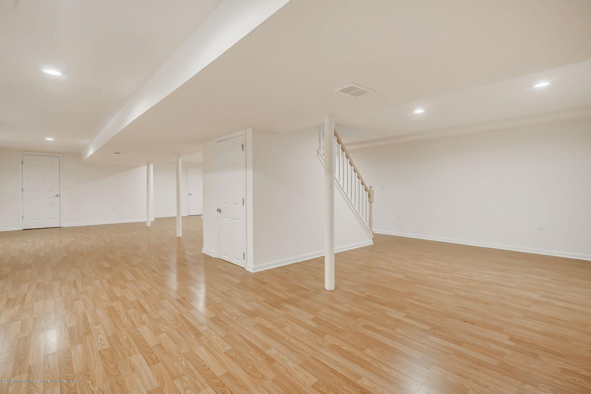 8 Saddle Ridge Road Colts Neck, NJ 07722 - Photo 27 of 35 a view of an empty room with wooden floor