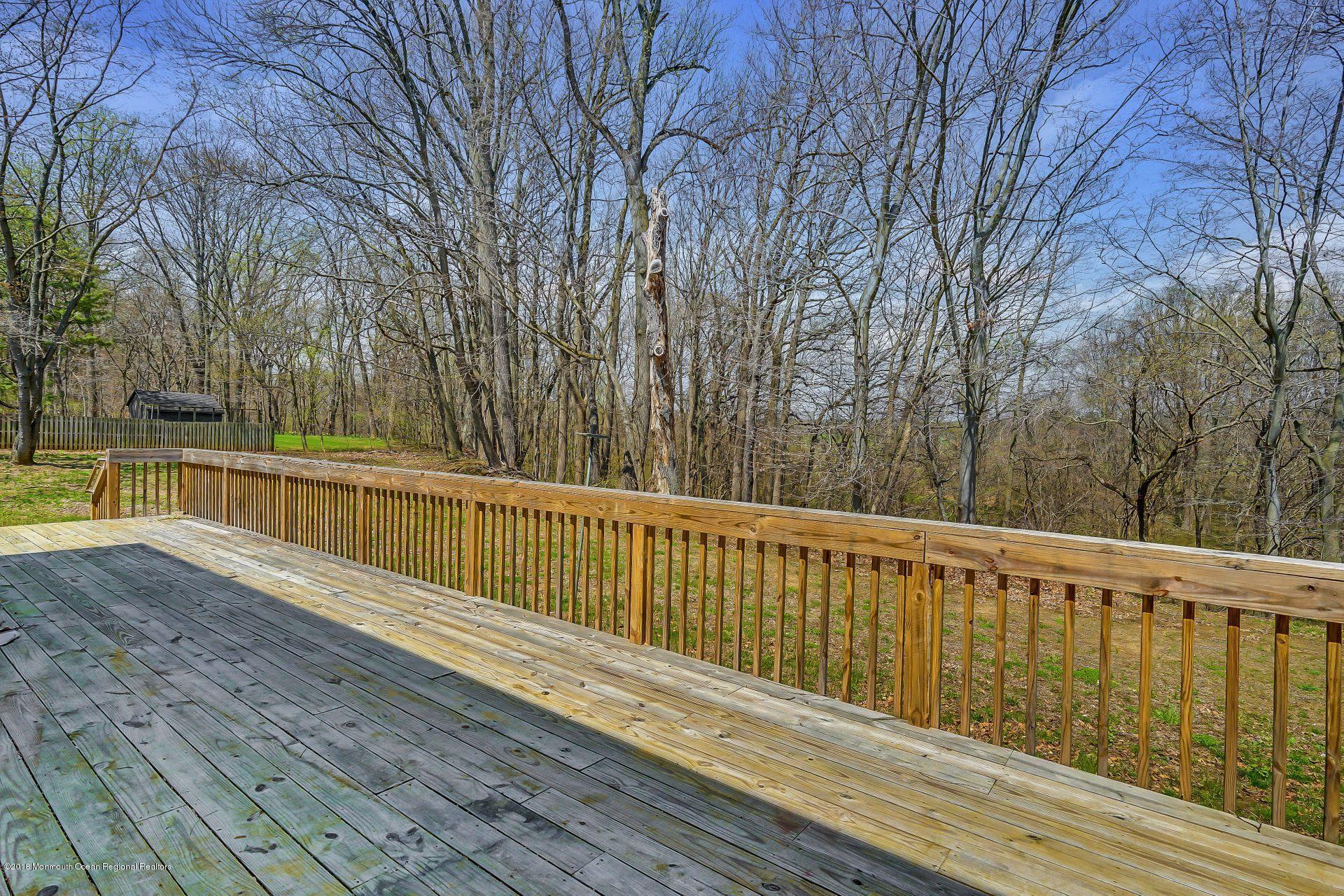 8 Saddle Ridge Road Colts Neck, NJ 07722 - Photo 30 of 35 a view of deck with a large trees