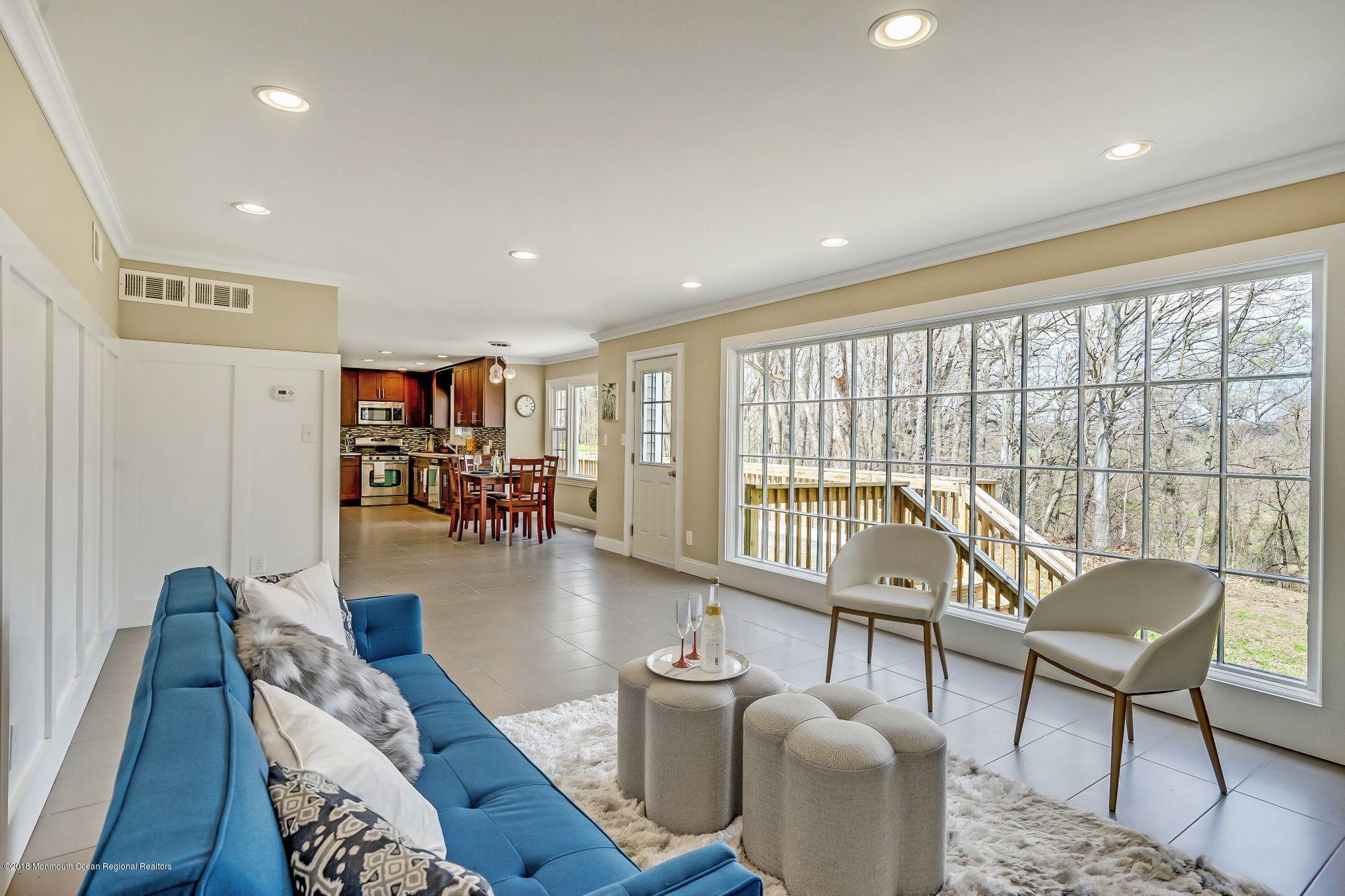 8 Saddle Ridge Road Colts Neck, NJ 07722 - Photo 9 of 35 a living room with furniture and a table