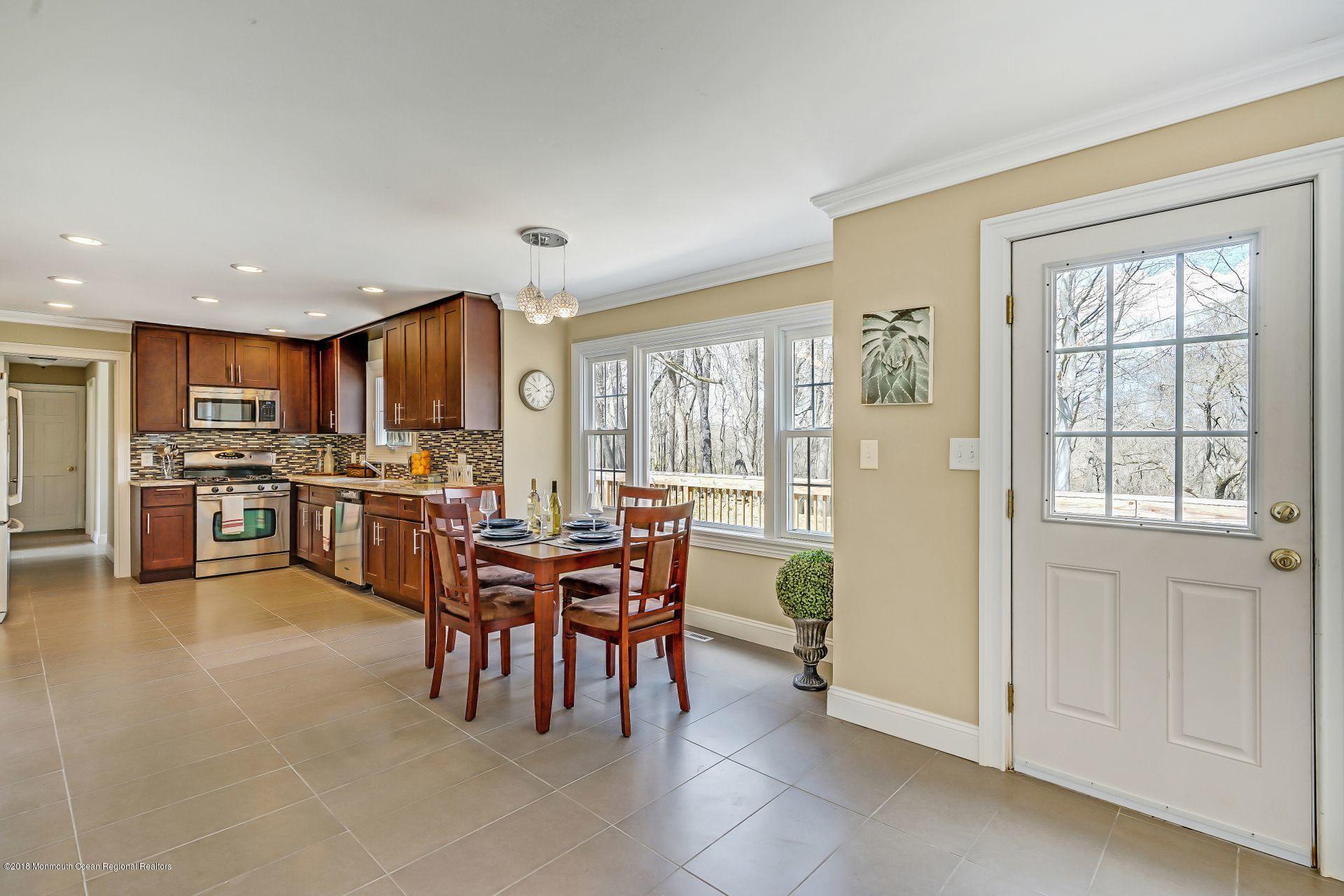 8 Saddle Ridge Road Colts Neck, NJ 07722 - Photo 10 of 35 a open kitchen with cabinets and stainless steel appliances