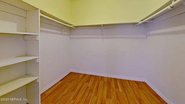 a view of a room with wooden floor and small space