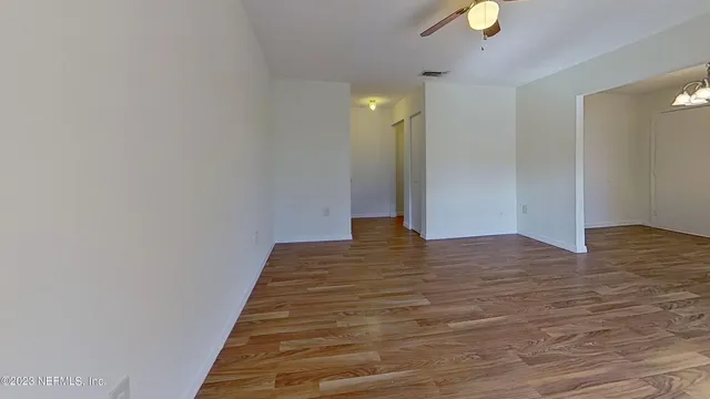 a view of a room with wooden floor and staircase