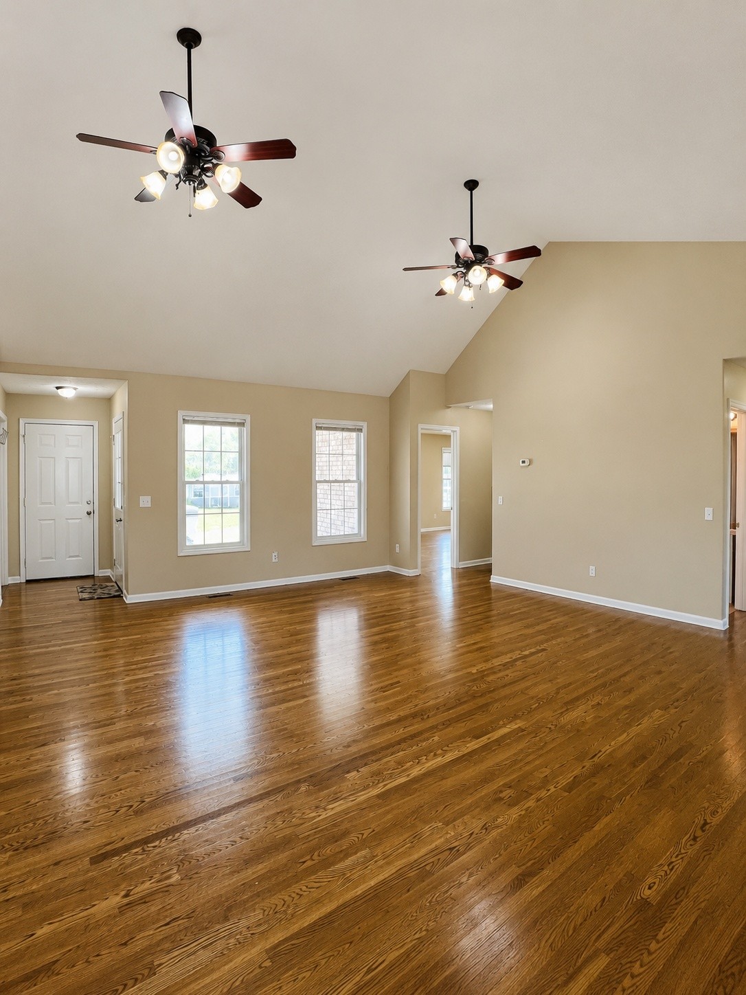 663 Jackson Road Portland, TN 37148 - Photo 6 of 32 an empty room with wooden floor fan and windows