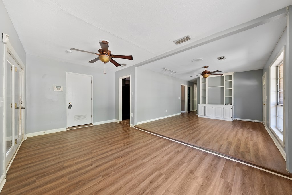 6263 Potomac Circle Columbus, GA 31909 - Photo 8 of 31 a view of empty room with wooden floor and fan