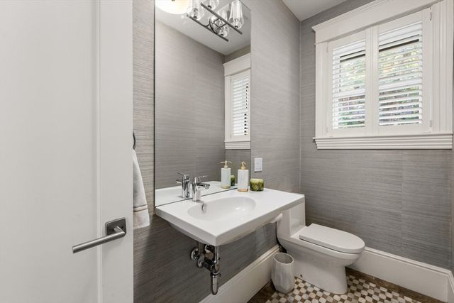 a bathroom with a sink toilet and a mirror