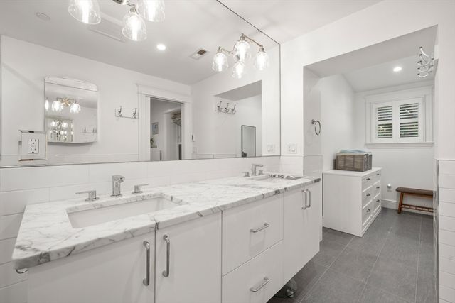 a bathroom with a double vanity sink and mirror