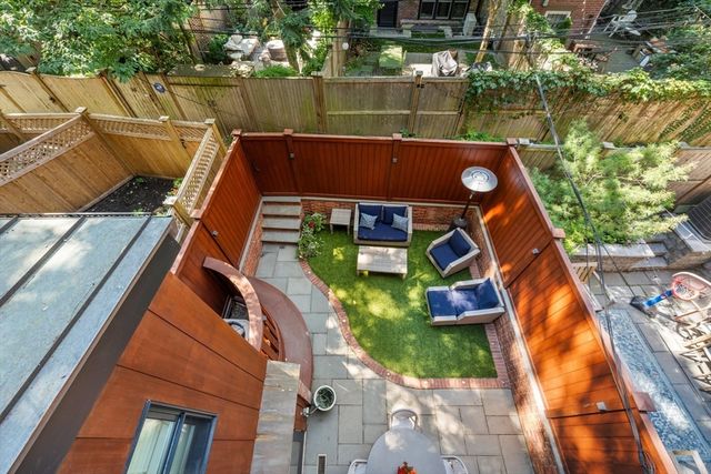 a view of a patio with iron fence