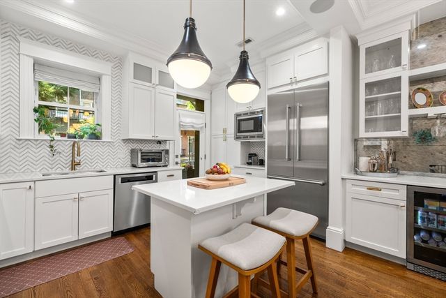 a kitchen with a sink cabinets and wooden floor