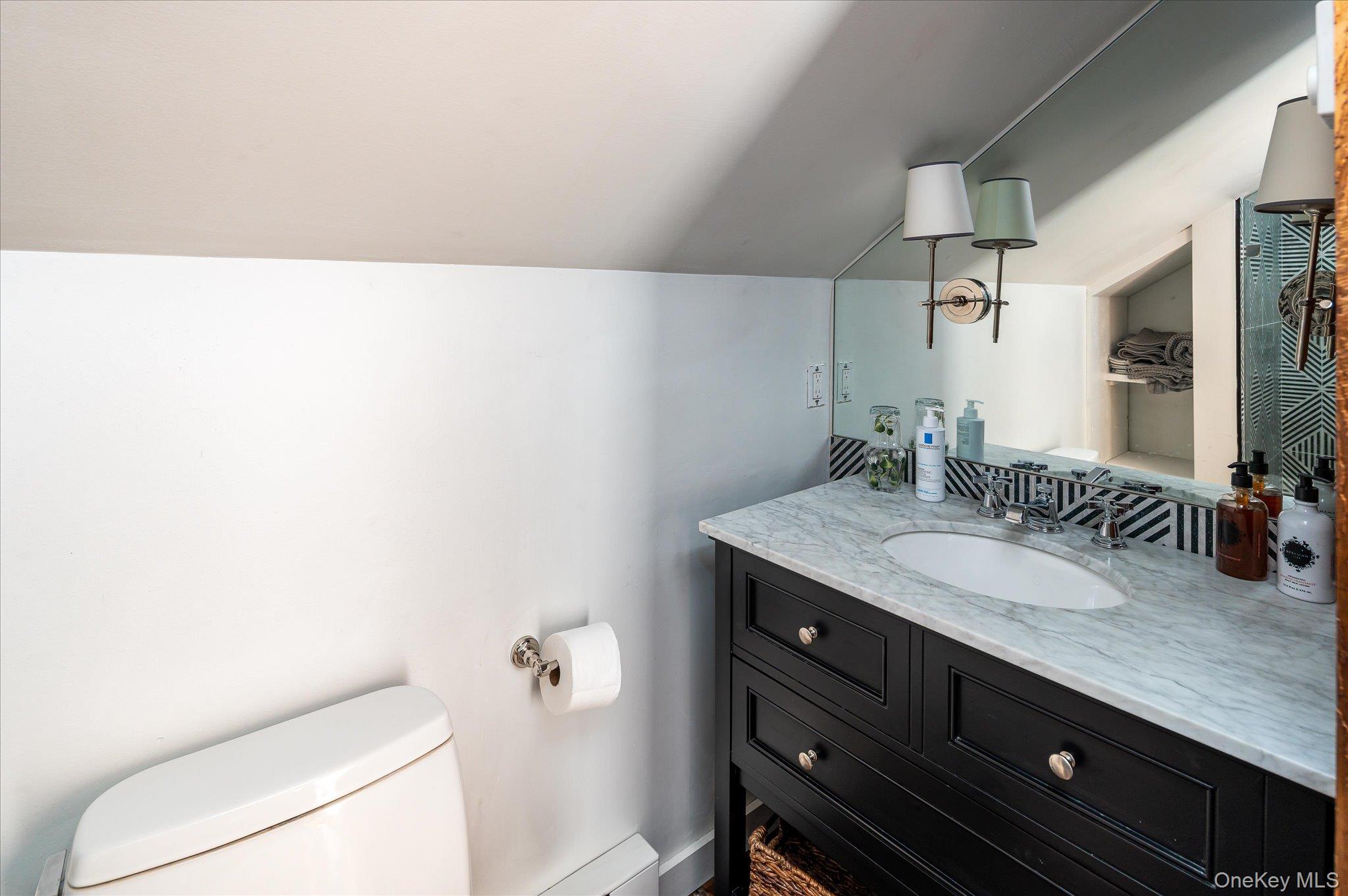459 Old Post Road Bedford, NY 10506 - Photo 19 of 24 a bathroom with a granite countertop sink a toilet and a mirror