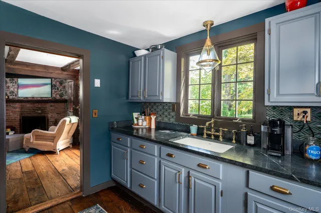 a kitchen with granite countertop a sink and a counter top space