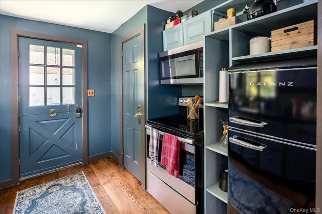 a view of an entryway and wooden floor