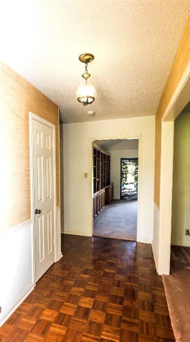 a view of a livingroom with wooden floor and stairs