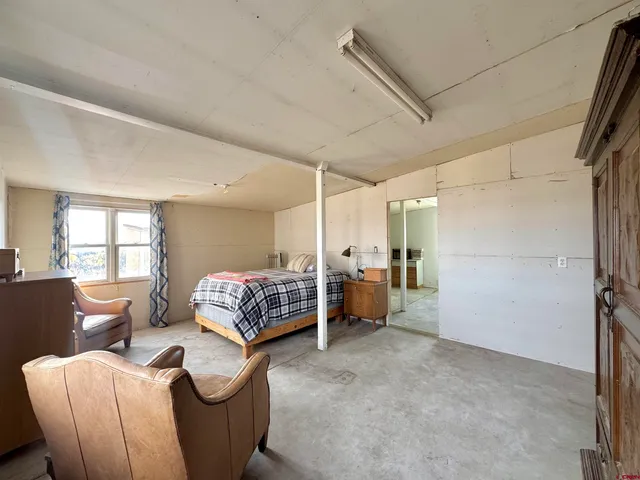 a bedroom with furniture and a window