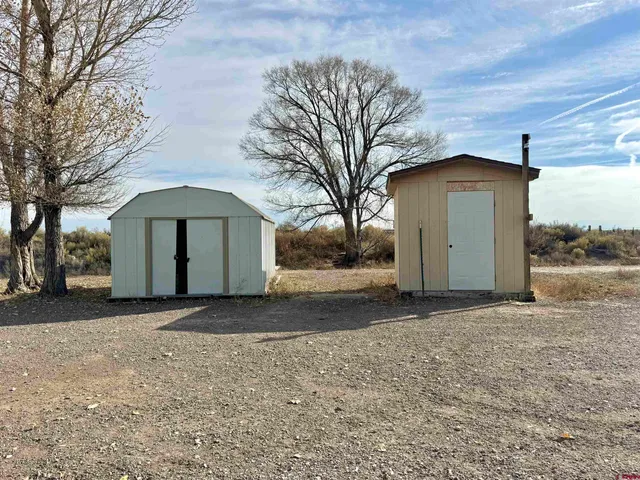 a view of a house with a yard and garage