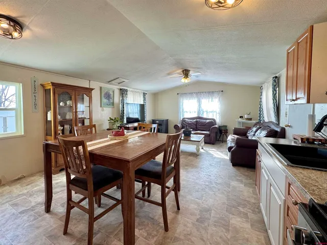 a large kitchen with a table and chairs