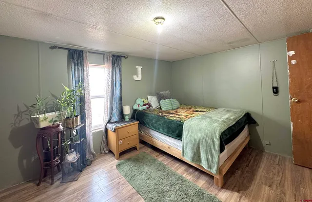 a bedroom with a bed and a potted plant