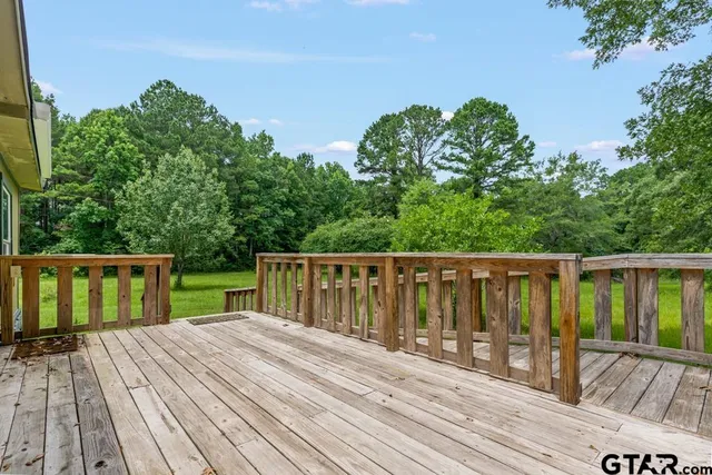 a balcony with wooden floor and fence