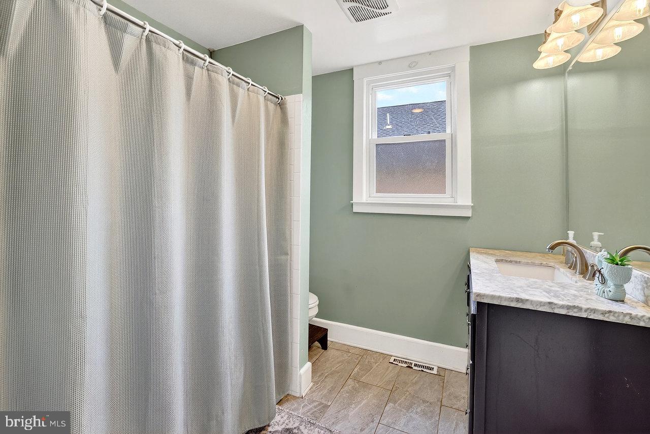 512 Spruce Street Delanco, NJ 08075 - Photo 12 of 24 a bathroom with a granite countertop sink and a mirror