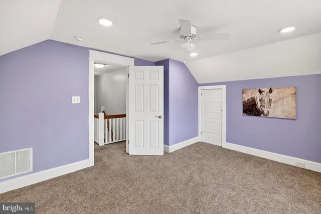 a view of an empty room with a fan