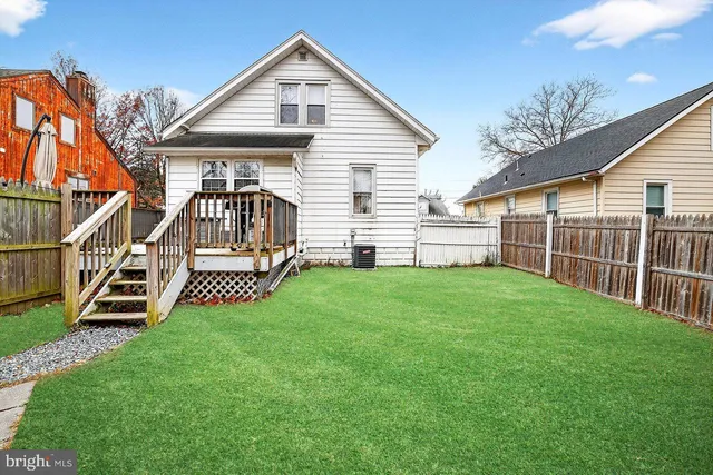 a view of a house with a yard and deck