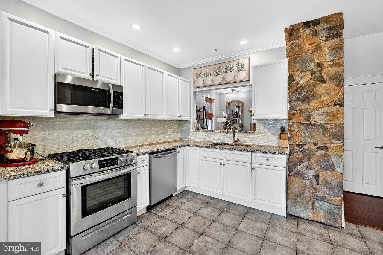 512 Spruce Street Delanco, NJ 08075 - Photo 9 of 24 a kitchen with stainless steel appliances granite countertop a stove a sink and a microwave
