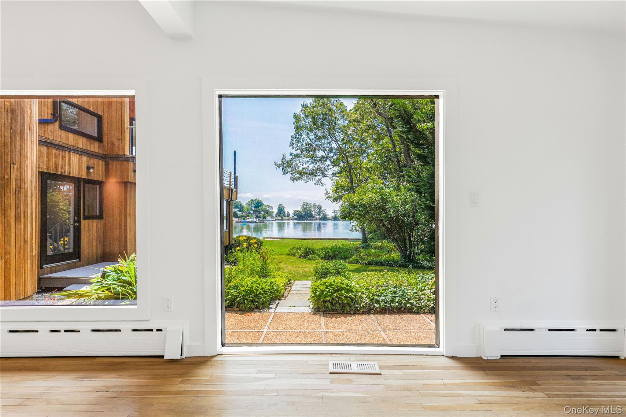 1160 Greacen Point Road Mamaroneck, NY 10543 - Photo 14 of 45 Floor to ceiling windows take full advantage of the views.