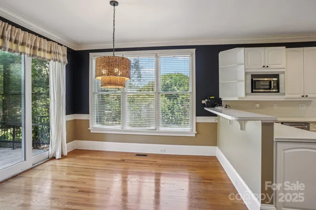 a view of a kitchen with a sink dishwasher and wooden floor