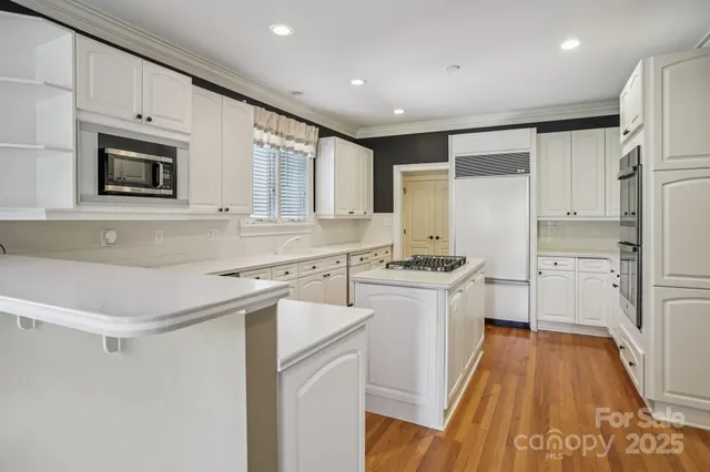 a kitchen with a sink stove and refrigerator