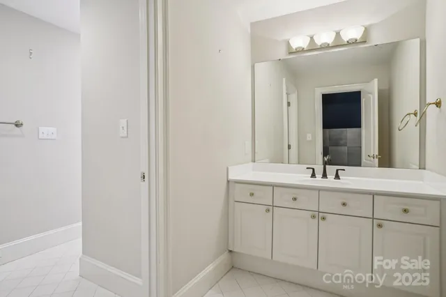 a bathroom with a double vanity sink and a mirror