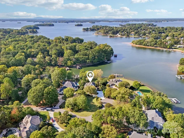 view of a lake with boats and trees all around