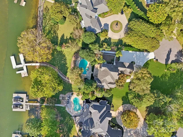 an aerial view of a house with a yard and green space