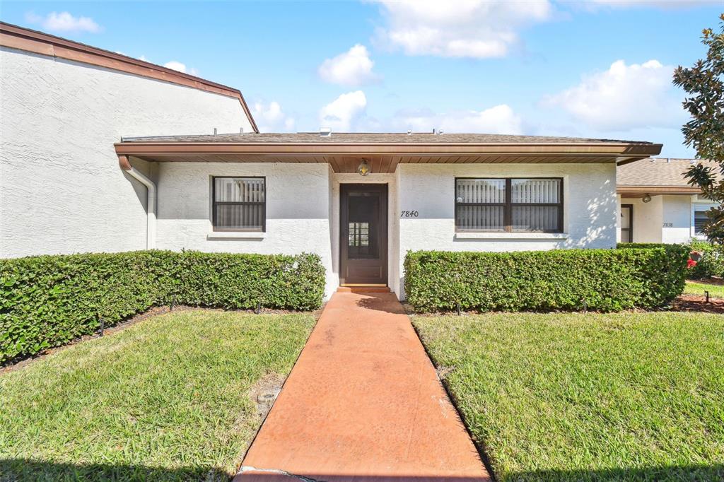 7840 Radcliffe Circle Port Richey, FL 34668 - Photo 1 of 1 front view of a house with a yard