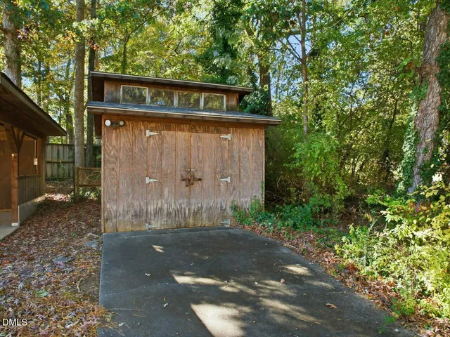 a view of an empty room with a fireplace and a window