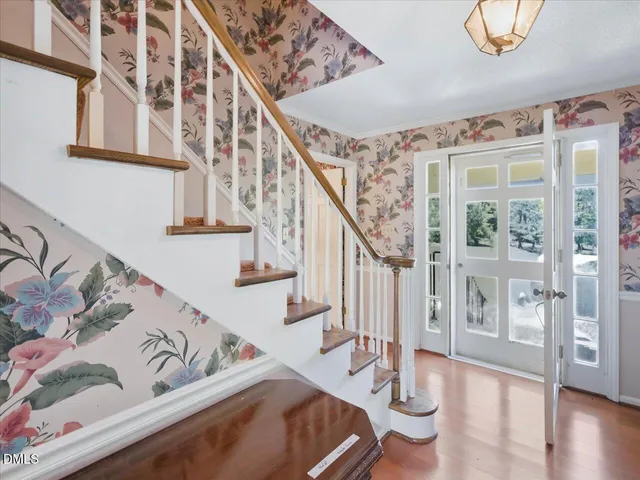 a view of an empty room with a fireplace and a window