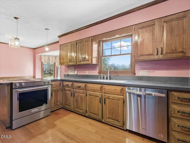 a view of entryway and hall with wooden floor