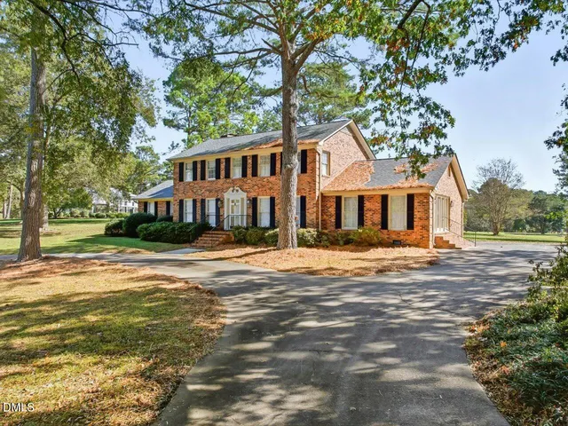 a view of a brick building next to a yard