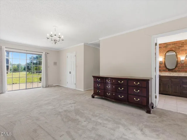 a aerial view of a house with a big yard and large trees