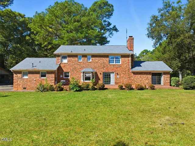 a view of house with backyard outdoor seating and barbeque oven