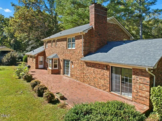a view of a big yard with large trees