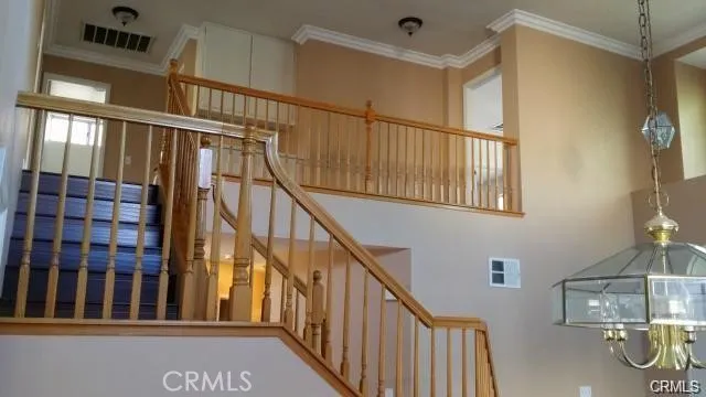a view of staircase with railing and a window