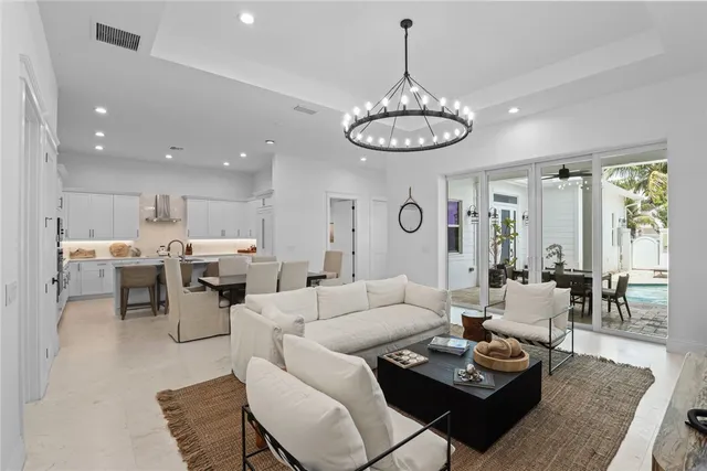 a living room with lots of living room furniture and kitchen view