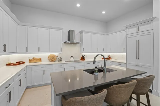 a kitchen with granite countertop a table chairs stove and cabinets