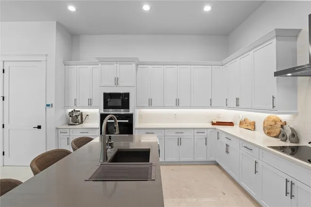 a kitchen with cabinets a sink and appliances