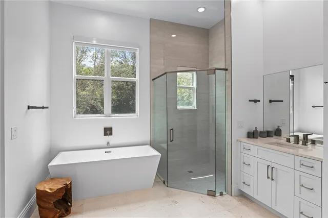 a bathroom with a tub sink toilet and a shower