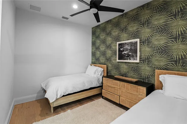 a bedroom with a bed and a wall painting