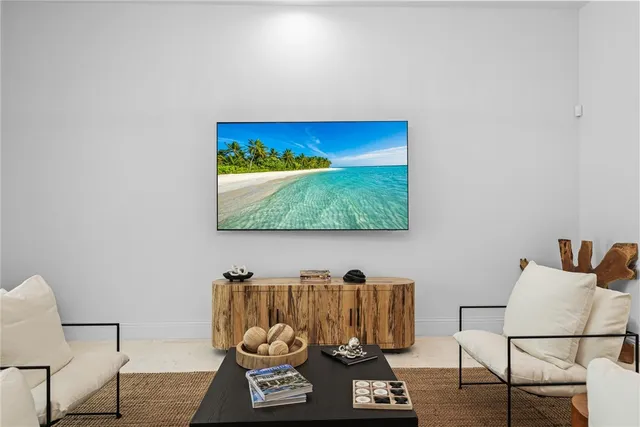 a view of a living room with furniture and a wooden floor