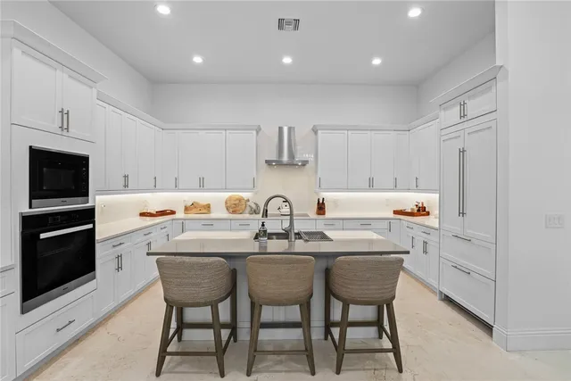 a kitchen with a dining table and chairs