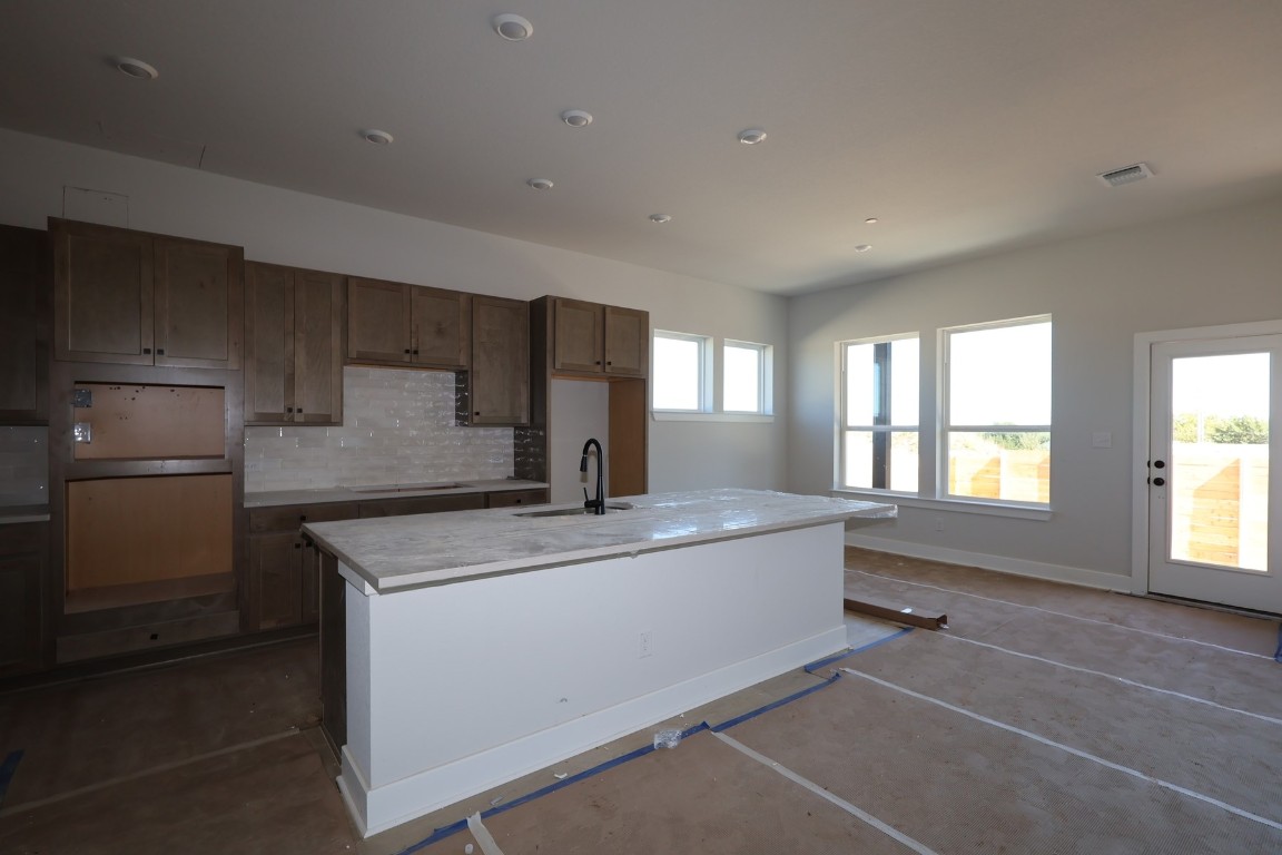 805 Nadal Path Round Rock, TX 78664 - Photo 2 of 17 a kitchen with stainless steel appliances granite countertop a sink and a refrigerator