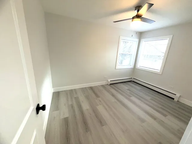 wooden floor in an empty room with a window