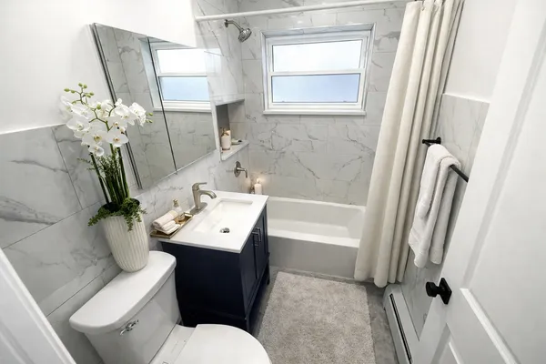 a bathroom with a sink toilet and shower